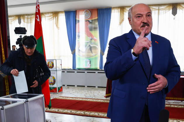 MINSK, BELARUS - FEBRUARY 27, 2022: Belarusian President Alexander Lukashenko (R) talks to reporters at a polling station after casting his vote in the 2022 Belarusian constitutional referendum. In August 2020, mass protests erupted in major cities across Belarus after the results of the 2020 Belarusian presidential election were announced. Belarusian President Lukashenko announced plans for amendments to the constitution and his readiness to redistribute presidential powers to the other branches of government. Peter Kovalev TASS  TS12590D