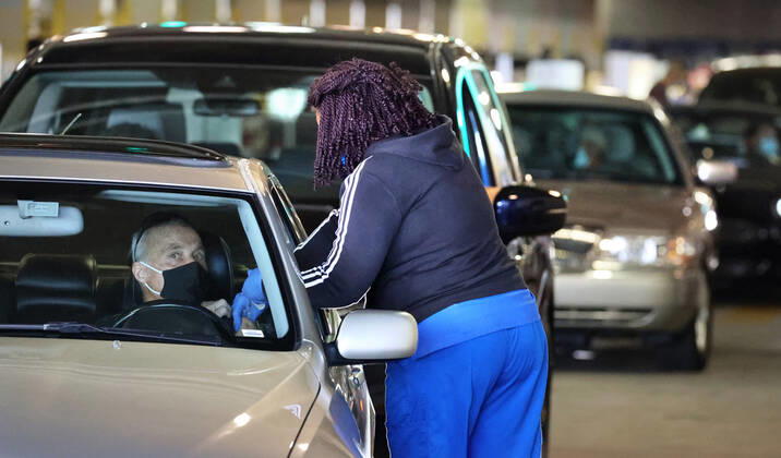 February 22, 2021, Orlando, FL, USA: A Florida resident gets vaccinated at the drive-thru site at the Orange County Convention Center in Orlando, Monday, Feb. 22, 2021. At least four of the experts whose research was cited in a study on vaccines for children say their work was taken out of context. They said they disagreed with Florida Surgeon General Joseph Ladapoâ€⠢s conclusion that the vaccine was more dangerous than the virus for healthy children. Orlando USA - ZUMAm67_ 20210222_zaf_m67_092 Copyright: xJoexBurbankx