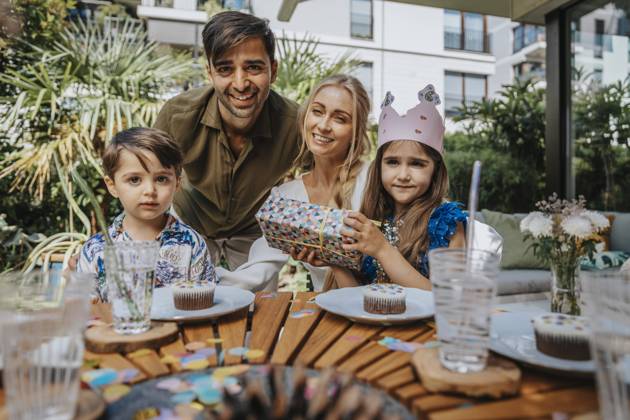 Smiling parents with children on birthday party model released property released, MFF08573