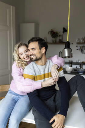 Smiling girlfriend embracing boyfriend at home model released, Symbolfoto property released, PESF03574