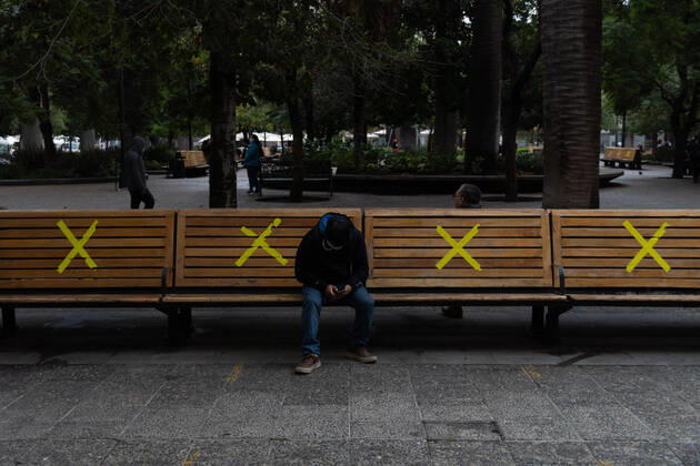 April 27, 2022, Santiago, Metropolitana, Chile: A man sits on some benches, marked with X at the start of the pandemic, in downtown Santiago, Chile. Santiago Chile - ZUMAb332 20220427_zip_b332_003 Copyright: xMatiasxBasualdox