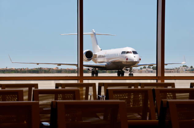 Business plane parked in an airport with seats on foreground. Focus on the plane. , 3044277.jpg, seat, metal, plane, angled, mode, travel, business, jet, private, vehicle, transport, airplane, blue, airport, air, white, corporate, contemporary, asphalt, commercial, luxury, class, stationary, transportation, sky, upper, space, nobody, horizontal, star, wealth, charter, parked, business, technology, challenger, object, front, sparse, single, road, chassis, wing,