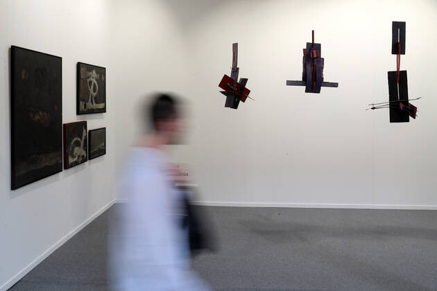 (220519) -- LISBON, May 19, 2022 -- A visitor walks past exhibits at the ARCOlisboa international contemporary art fair in Lisbon, Portugal, on May 19, 2022. The ARCOlisboa 2022 which kicked off on Thursday, will last till May 22. (Photo by Xinhua) PORTUGAL-LISBON-INTERNATIONAL CONTEMPORARY ART FAIR PedroxFiuza 