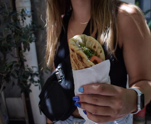 Greece: Popular street food Souvlaki prices soar under inflation A woman holds the traditional street food Souvlaki she has just bought from a restaurant. The price of Greece s most popular street food soar, as inflation has increased to around 10.7 percent in May from 10.2 percent in April, reaching its highest level in 28 years. Athens Greece Copyright: DimitrisxAspiotis
