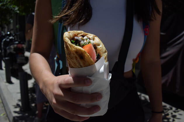 Greece: Popular street food Souvlaki prices soar under inflation A woman holds the traditional street food Souvlaki she has just bought from a restaurant. The price of Greece s most popular street food soar, as inflation has increased to around 10.7 percent in May from 10.2 percent in April, reaching its highest level in 28 years. Athens Greece Copyright: DimitrisxAspiotis