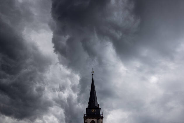 Dunkle Wolken über dem Kirchturm Dunkle Wolken eines Schauers sind am Abend am Himmel über dem Kirchturm der katholischen Kirche St.-Ursula in Oberursel zu sehen., Oberursel Hessen Deutschland