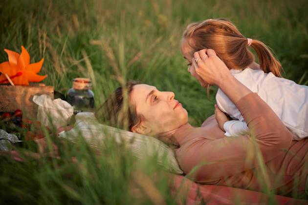 Mother talking with daughter lying on grass model released, Symbolfoto, ZEDF04620