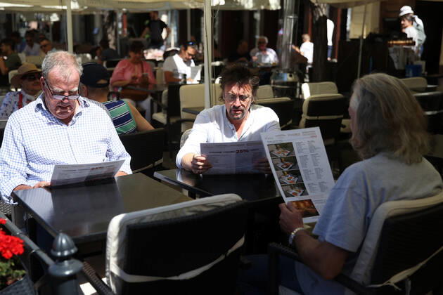 June 24, 2022, Krakow, Poland: The Grand Tour stars, Jeremy Clarkson, Richard Hammond and James May, sit at a coffee shop on the Main Square in Cracow, Poland, while on tour filming the show. The Grand Tour is a British motoring television series, created by Jeremy Clarkson, Richard Hammond, James May, and Andy Wilman, made for Amazon exclusively for its online streaming service Amazon Prime Video which premiered in 2016. The programme was conceived in the wake of the departure of Clarkson, Hammond, May and Wilman from the BBC series Top Gear. Krakow Poland - ZUMAs197 20220624_zaa_s197_602 Copyright: xVitoxCorleonex