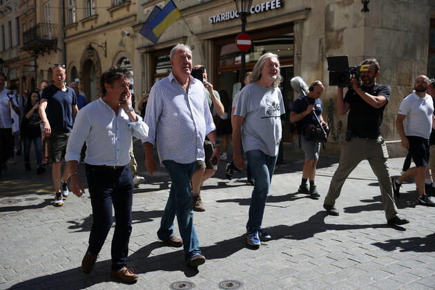 June 24, 2022, Krakow, Poland: The Grand Tour stars, Jeremy Clarkson, Richard Hammond and James May, walk along the Main Square in Cracow, Poland, while on tour filming the show. The Grand Tour is a British motoring television series, created by Jeremy Clarkson, Richard Hammond, James May, and Andy Wilman, made for Amazon exclusively for its online streaming service Amazon Prime Video which premiered in 2016. The programme was conceived in the wake of the departure of Clarkson, Hammond, May and Wilman from the BBC series Top Gear. Krakow Poland - ZUMAs197 20220624_zaa_s197_601 Copyright: xVitoxCorleonex