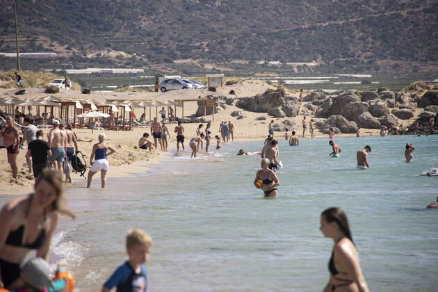 Tourism In Greece - Falassarna Beach In Crete Island Tourism in Greece - The exotic beach of Falassarna at the western side of Crete island. Falasarna bay with 5 beaches with whitish sand and crystal clear transparent tropical turquoise water hosts some of the most famous beaches in Greece, which has been awarded as the best beach of Crete and voted as one of the 10 best beaches in Europe several times in the past. Local people and tourists are seen relaxing, sunbathing, tanning, swimming, doing water sports and walking. Tourism is bouncing back with reservations exceeding the pre-pandemic numbers, putting Greece and the Greek islands on high demand. Tourists travel after the Covid-19 Coronavirus pandemic. Falassarna, Chania, Crete island, Copyright: xNicolasxEconomoux originalFilename: economou-tourismi220614_np5hK