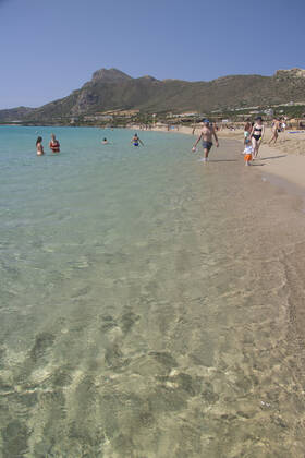 Tourism In Greece - Falassarna Beach In Crete Island Tourism in Greece - The exotic beach of Falassarna at the western side of Crete island. Falasarna bay with 5 beaches with whitish sand and crystal clear transparent tropical turquoise water hosts some of the most famous beaches in Greece, which has been awarded as the best beach of Crete and voted as one of the 10 best beaches in Europe several times in the past. Local people and tourists are seen relaxing, sunbathing, tanning, swimming, doing water sports and walking. Tourism is bouncing back with reservations exceeding the pre-pandemic numbers, putting Greece and the Greek islands on high demand. Tourists travel after the Covid-19 Coronavirus pandemic. Falassarna, Chania, Crete island, Copyright: xNicolasxEconomoux originalFilename: economou-tourismi220614_npazX
