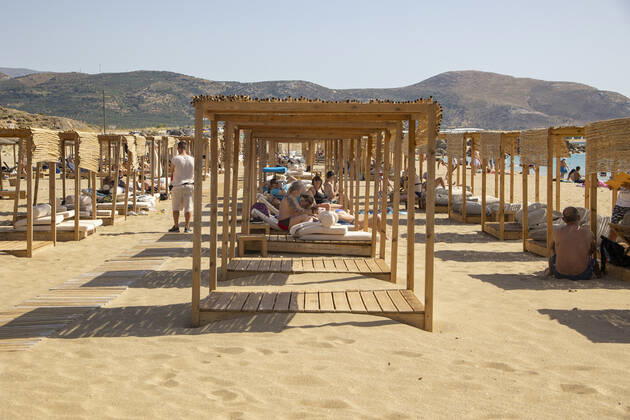 Tourism In Greece - Falassarna Beach In Crete Island Tourism in Greece - The exotic beach of Falassarna at the western side of Crete island. Falasarna bay with 5 beaches with whitish sand and crystal clear transparent tropical turquoise water hosts some of the most famous beaches in Greece, which has been awarded as the best beach of Crete and voted as one of the 10 best beaches in Europe several times in the past. Local people and tourists are seen relaxing, sunbathing, tanning, swimming, doing water sports and walking. Tourism is bouncing back with reservations exceeding the pre-pandemic numbers, putting Greece and the Greek islands on high demand. Tourists travel after the Covid-19 Coronavirus pandemic. Falassarna, Chania, Crete island, Copyright: xNicolasxEconomoux originalFilename: economou-tourismi220614_npcdI