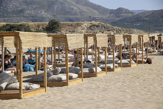 Tourism In Greece - Falassarna Beach In Crete Island Tourism in Greece - The exotic beach of Falassarna at the western side of Crete island. Falasarna bay with 5 beaches with whitish sand and crystal clear transparent tropical turquoise water hosts some of the most famous beaches in Greece, which has been awarded as the best beach of Crete and voted as one of the 10 best beaches in Europe several times in the past. Local people and tourists are seen relaxing, sunbathing, tanning, swimming, doing water sports and walking. Tourism is bouncing back with reservations exceeding the pre-pandemic numbers, putting Greece and the Greek islands on high demand. Tourists travel after the Covid-19 Coronavirus pandemic. Falassarna, Chania, Crete island, Copyright: xNicolasxEconomoux originalFilename: economou-tourismi220614_npcyf