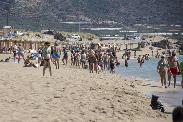 Tourism In Greece - Falassarna Beach In Crete Island Tourism in Greece - The exotic beach of Falassarna at the western side of Crete island. Falasarna bay with 5 beaches with whitish sand and crystal clear transparent tropical turquoise water hosts some of the most famous beaches in Greece, which has been awarded as the best beach of Crete and voted as one of the 10 best beaches in Europe several times in the past. Local people and tourists are seen relaxing, sunbathing, tanning, swimming, doing water sports and walking. Tourism is bouncing back with reservations exceeding the pre-pandemic numbers, putting Greece and the Greek islands on high demand. Tourists travel after the Covid-19 Coronavirus pandemic. Falassarna, Chania, Crete island, Copyright: xNicolasxEconomoux originalFilename: economou-tourismi220614_nphfq