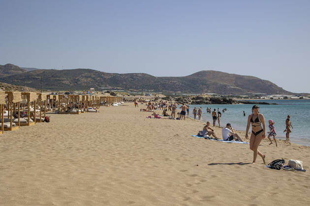Tourism In Greece - Falassarna Beach In Crete Island Tourism in Greece - The exotic beach of Falassarna at the western side of Crete island. Falasarna bay with 5 beaches with whitish sand and crystal clear transparent tropical turquoise water hosts some of the most famous beaches in Greece, which has been awarded as the best beach of Crete and voted as one of the 10 best beaches in Europe several times in the past. Local people and tourists are seen relaxing, sunbathing, tanning, swimming, doing water sports and walking. Tourism is bouncing back with reservations exceeding the pre-pandemic numbers, putting Greece and the Greek islands on high demand. Tourists travel after the Covid-19 Coronavirus pandemic. Falassarna, Chania, Crete island, Copyright: xNicolasxEconomoux originalFilename: economou-tourismi220614_npxrh