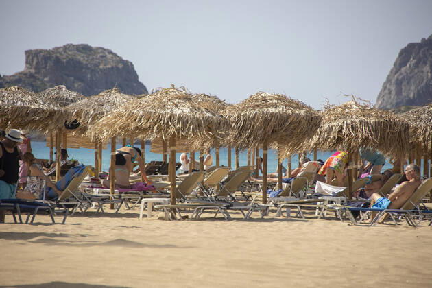 Tourism In Greece - Falassarna Beach In Crete Island Tourism in Greece - The exotic beach of Falassarna at the western side of Crete island. Falasarna bay with 5 beaches with whitish sand and crystal clear transparent tropical turquoise water hosts some of the most famous beaches in Greece, which has been awarded as the best beach of Crete and voted as one of the 10 best beaches in Europe several times in the past. Local people and tourists are seen relaxing, sunbathing, tanning, swimming, doing water sports and walking. Tourism is bouncing back with reservations exceeding the pre-pandemic numbers, putting Greece and the Greek islands on high demand. Tourists travel after the Covid-19 Coronavirus pandemic. Falassarna, Chania, Crete island, Copyright: xNicolasxEconomoux originalFilename: economou-tourismi220614_np96n