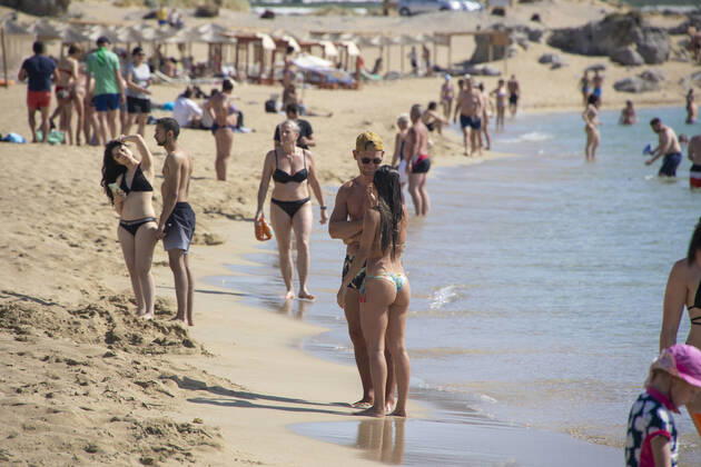 Tourism In Greece - Falassarna Beach In Crete Island Tourism in Greece - The exotic beach of Falassarna at the western side of Crete island. Falasarna bay with 5 beaches with whitish sand and crystal clear transparent tropical turquoise water hosts some of the most famous beaches in Greece, which has been awarded as the best beach of Crete and voted as one of the 10 best beaches in Europe several times in the past. Local people and tourists are seen relaxing, sunbathing, tanning, swimming, doing water sports and walking. Tourism is bouncing back with reservations exceeding the pre-pandemic numbers, putting Greece and the Greek islands on high demand. Tourists travel after the Covid-19 Coronavirus pandemic. Falassarna, Chania, Crete island, Copyright: xNicolasxEconomoux originalFilename: economou-tourismi220614_npfbd
