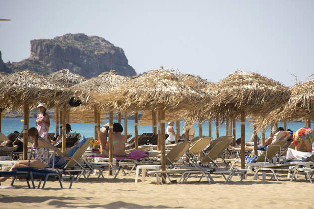 Tourism In Greece - Falassarna Beach In Crete Island Tourism in Greece - The exotic beach of Falassarna at the western side of Crete island. Falasarna bay with 5 beaches with whitish sand and crystal clear transparent tropical turquoise water hosts some of the most famous beaches in Greece, which has been awarded as the best beach of Crete and voted as one of the 10 best beaches in Europe several times in the past. Local people and tourists are seen relaxing, sunbathing, tanning, swimming, doing water sports and walking. Tourism is bouncing back with reservations exceeding the pre-pandemic numbers, putting Greece and the Greek islands on high demand. Tourists travel after the Covid-19 Coronavirus pandemic. Falassarna, Chania, Crete island, Copyright: xNicolasxEconomoux originalFilename: economou-tourismi220614_npfl6
