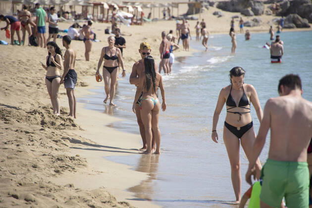 Tourism In Greece - Falassarna Beach In Crete Island Tourism in Greece - The exotic beach of Falassarna at the western side of Crete island. Falasarna bay with 5 beaches with whitish sand and crystal clear transparent tropical turquoise water hosts some of the most famous beaches in Greece, which has been awarded as the best beach of Crete and voted as one of the 10 best beaches in Europe several times in the past. Local people and tourists are seen relaxing, sunbathing, tanning, swimming, doing water sports and walking. Tourism is bouncing back with reservations exceeding the pre-pandemic numbers, putting Greece and the Greek islands on high demand. Tourists travel after the Covid-19 Coronavirus pandemic. Falassarna, Chania, Crete island, Copyright: xNicolasxEconomoux originalFilename: economou-tourismi220614_npKH6