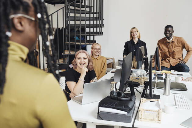 Smiling colleagues looking at businesswoman during meeting in office Sweden, Stockholm, model released, property released Copyright: xMaskotx , MA94206 MA94206