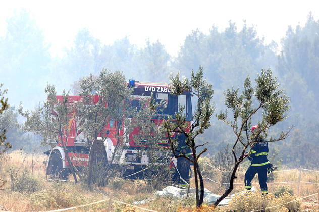 PXL_A fire near Vodice, Croatia Fire in an open area near the Velika Mrdakovica archaeological site in the Vodice hinterland, Croatia on July 13, 2022. About 30 firefighters with a dozen vehicles are on the ground, and two Canadairs joined the ground forces in extinguishing the fire. There are pine forests above, low vegetation, and endangered buildings. DuskoxJaramaz PIXSELL