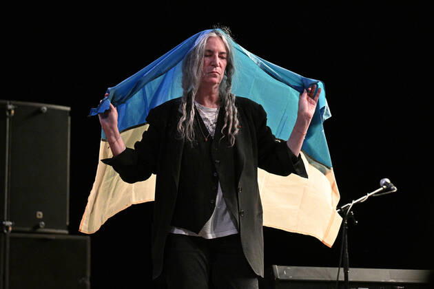 American singer and musician Patti Smith performs during her concert in Prague, Czech Republic, on July 19, 2022. On the photo Smith holds the Ukrainian flag. (CTKxPhoto MichalxKamaryt) CTKPhotoP2022071907991  kmt
