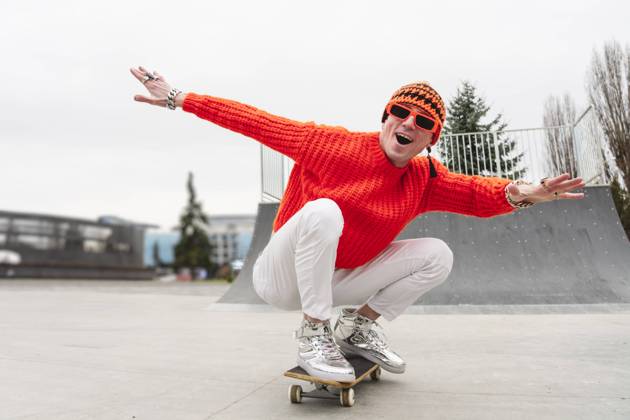 Happy mature man with arms outstretched enjoying on skateboard model released, Symbolfoto, OSF00153