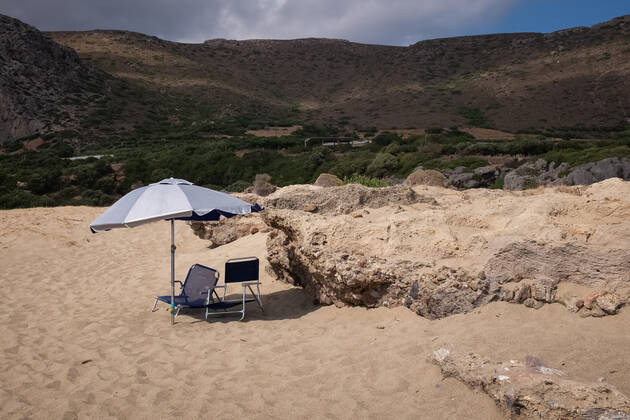 Tourism In Greece - Falassarna Beach In Crete Island An umbrella with two chairs at Falassarna beach near Chania, Crete Island, Greece on August 14, 2022. Falassarna is located 59 kilometers west of Chania. Today is one of the most famous destinations in Crete, for its beaches and for reasons of ecological interest. Falassarna Greece Copyright: xNikolasxKokovlisx originalFilename: kokovlis-notitle220814_npV3F