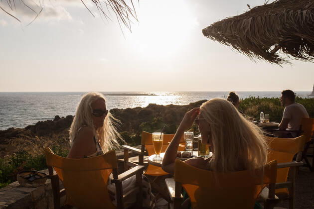 Tourism In Greece - Falassarna Beach In Crete Island People are enjoy their drink at a cafe-bar watching the sunset at Falassarna beach near Chania, Crete Island, Greece on August 14, 2022. Falassarna is located 59 kilometers west of Chania. Today is one of the most famous destinations in Crete, for its beaches and for reasons of ecological interest. Falassarna Greece Copyright: xNikolasxKokovlisx originalFilename: kokovlis-notitle220814_npLQ1