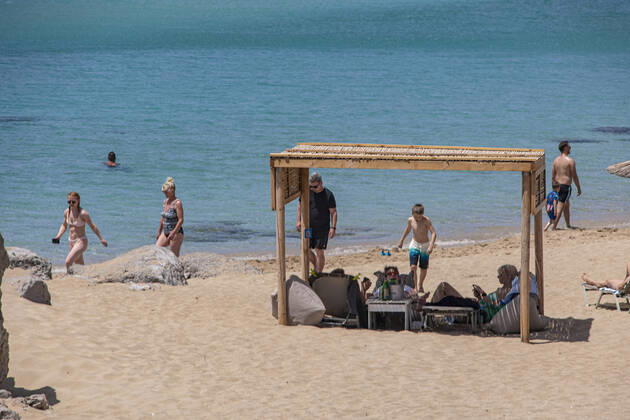 Tourism In Greece - Falassarna Beach In Crete Island Tourism in Greece - The exotic beach of Falassarna at the western side of Crete island during a high-temperature day, heatwave. Falasarna bay with 5 beaches made of whitish sand and crystal clear transparent tropical turquoise water hosts some of the most famous beaches in Greece, which has been awarded multiple times as the best beach of Crete and voted as one of the 10 best beaches in Europe several times in the past. Local people and tourists are seen relaxing, sunbathing, tanning, swimming, doing water sports and walking. Tourism is bouncing back with reservations overpassing the pre-pandemic numbers, putting Greece and the Greek islands on high demand. Tourists travel after the Covid Copyright: xNicolasxEconomoux originalFilename: economou-tourismi220818_npQ8H