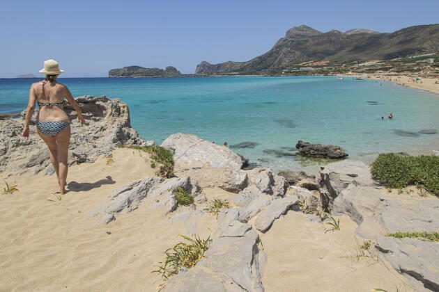 Tourism In Greece - Falassarna Beach In Crete Island Tourism in Greece - The exotic beach of Falassarna at the western side of Crete island during a high-temperature day, heatwave. Falasarna bay with 5 beaches made of whitish sand and crystal clear transparent tropical turquoise water hosts some of the most famous beaches in Greece, which has been awarded multiple times as the best beach of Crete and voted as one of the 10 best beaches in Europe several times in the past. Local people and tourists are seen relaxing, sunbathing, tanning, swimming, doing water sports and walking. Tourism is bouncing back with reservations overpassing the pre-pandemic numbers, putting Greece and the Greek islands on high demand. Tourists travel after the Covid Copyright: xNicolasxEconomoux originalFilename: economou-tourismi220818_npbM4