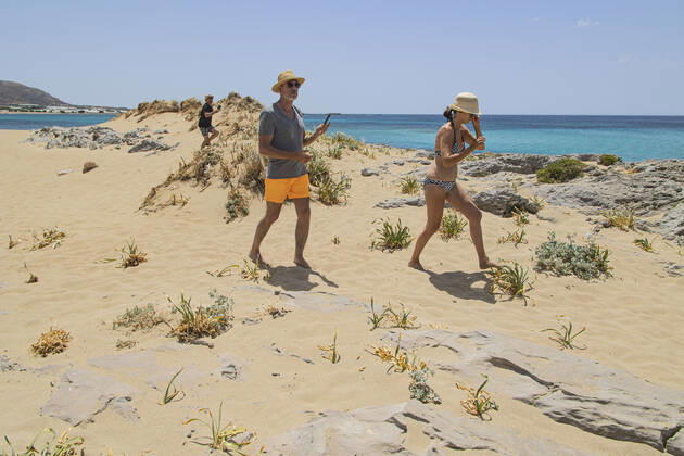 Tourism In Greece - Falassarna Beach In Crete Island Tourism in Greece - The exotic beach of Falassarna at the western side of Crete island during a high-temperature day, heatwave. Falasarna bay with 5 beaches made of whitish sand and crystal clear transparent tropical turquoise water hosts some of the most famous beaches in Greece, which has been awarded multiple times as the best beach of Crete and voted as one of the 10 best beaches in Europe several times in the past. Local people and tourists are seen relaxing, sunbathing, tanning, swimming, doing water sports and walking. Tourism is bouncing back with reservations overpassing the pre-pandemic numbers, putting Greece and the Greek islands on high demand. Tourists travel after the Covid Copyright: xNicolasxEconomoux originalFilename: economou-tourismi220818_npgFW