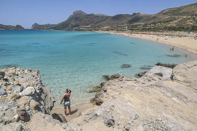 Tourism In Greece - Falassarna Beach In Crete Island Tourism in Greece - The exotic beach of Falassarna at the western side of Crete island during a high-temperature day, heatwave. Falasarna bay with 5 beaches made of whitish sand and crystal clear transparent tropical turquoise water hosts some of the most famous beaches in Greece, which has been awarded multiple times as the best beach of Crete and voted as one of the 10 best beaches in Europe several times in the past. Local people and tourists are seen relaxing, sunbathing, tanning, swimming, doing water sports and walking. Tourism is bouncing back with reservations overpassing the pre-pandemic numbers, putting Greece and the Greek islands on high demand. Tourists travel after the Covid Copyright: xNicolasxEconomoux originalFilename: economou-tourismi220818_np3hm