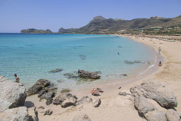 Tourism In Greece - Falassarna Beach In Crete Island Tourism in Greece - The exotic beach of Falassarna at the western side of Crete island during a high-temperature day, heatwave. Falasarna bay with 5 beaches made of whitish sand and crystal clear transparent tropical turquoise water hosts some of the most famous beaches in Greece, which has been awarded multiple times as the best beach of Crete and voted as one of the 10 best beaches in Europe several times in the past. Local people and tourists are seen relaxing, sunbathing, tanning, swimming, doing water sports and walking. Tourism is bouncing back with reservations overpassing the pre-pandemic numbers, putting Greece and the Greek islands on high demand. Tourists travel after the Covid Copyright: xNicolasxEconomoux originalFilename: economou-tourismi220818_np4KP