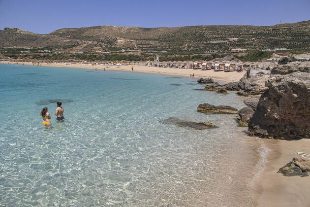 Tourism In Greece - Falassarna Beach In Crete Island Tourism in Greece - The exotic beach of Falassarna at the western side of Crete island during a high-temperature day, heatwave. Falasarna bay with 5 beaches made of whitish sand and crystal clear transparent tropical turquoise water hosts some of the most famous beaches in Greece, which has been awarded multiple times as the best beach of Crete and voted as one of the 10 best beaches in Europe several times in the past. Local people and tourists are seen relaxing, sunbathing, tanning, swimming, doing water sports and walking. Tourism is bouncing back with reservations overpassing the pre-pandemic numbers, putting Greece and the Greek islands on high demand. Tourists travel after the Covid Copyright: xNicolasxEconomoux originalFilename: economou-tourismi220818_npmWc