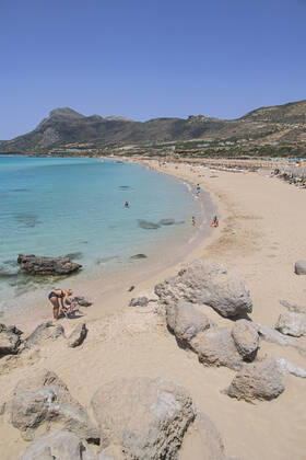 Tourism In Greece - Falassarna Beach In Crete Island Tourism in Greece - The exotic beach of Falassarna at the western side of Crete island during a high-temperature day, heatwave. Falasarna bay with 5 beaches made of whitish sand and crystal clear transparent tropical turquoise water hosts some of the most famous beaches in Greece, which has been awarded multiple times as the best beach of Crete and voted as one of the 10 best beaches in Europe several times in the past. Local people and tourists are seen relaxing, sunbathing, tanning, swimming, doing water sports and walking. Tourism is bouncing back with reservations overpassing the pre-pandemic numbers, putting Greece and the Greek islands on high demand. Tourists travel after the Covid Copyright: xNicolasxEconomoux originalFilename: economou-tourismi220818_npNZB