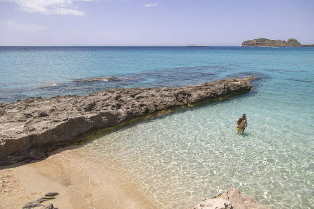 Tourism In Greece - Falassarna Beach In Crete Island Tourism in Greece - The exotic beach of Falassarna at the western side of Crete island during a high-temperature day, heatwave. Falasarna bay with 5 beaches made of whitish sand and crystal clear transparent tropical turquoise water hosts some of the most famous beaches in Greece, which has been awarded multiple times as the best beach of Crete and voted as one of the 10 best beaches in Europe several times in the past. Local people and tourists are seen relaxing, sunbathing, tanning, swimming, doing water sports and walking. Tourism is bouncing back with reservations overpassing the pre-pandemic numbers, putting Greece and the Greek islands on high demand. Tourists travel after the Covid Copyright: xNicolasxEconomoux originalFilename: economou-tourismi220818_npUkK
