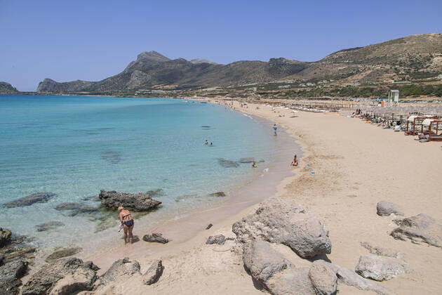Tourism In Greece - Falassarna Beach In Crete Island Tourism in Greece - The exotic beach of Falassarna at the western side of Crete island during a high-temperature day, heatwave. Falasarna bay with 5 beaches made of whitish sand and crystal clear transparent tropical turquoise water hosts some of the most famous beaches in Greece, which has been awarded multiple times as the best beach of Crete and voted as one of the 10 best beaches in Europe several times in the past. Local people and tourists are seen relaxing, sunbathing, tanning, swimming, doing water sports and walking. Tourism is bouncing back with reservations overpassing the pre-pandemic numbers, putting Greece and the Greek islands on high demand. Tourists travel after the Covid Copyright: xNicolasxEconomoux originalFilename: economou-tourismi220818_npR5v