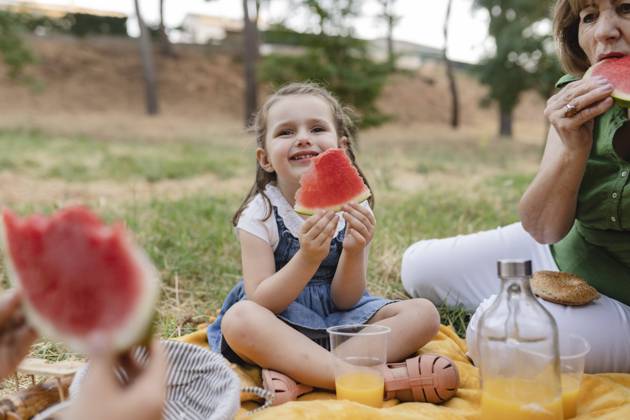 Cute girl holding watermelon sitting by grandmother model released, Symbolfoto, JCCMF06839