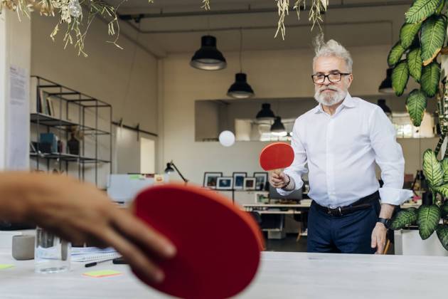 IMAGO Creative: Business - Work-Life Balance Businessman playing table tennis with coworker at office model released, Symbolfoto property released, MEUF07154