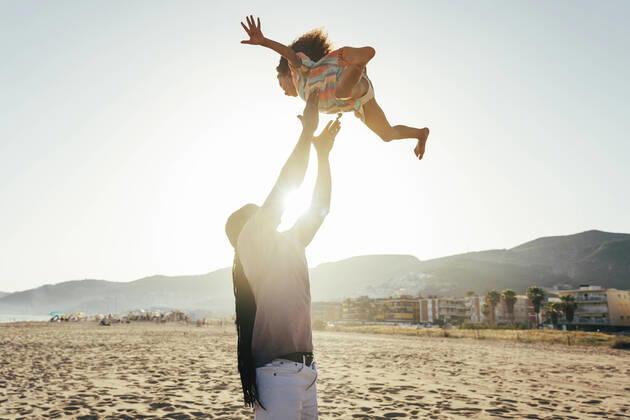 Playful father throwing daughter in air at beach model released, Symbolfoto, OIPF02120