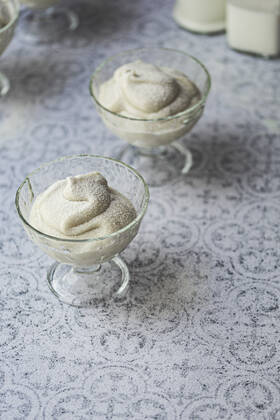 Coconut pudding dessert in a glass bowl against a tile background Coconut pudding dessert in a glass bowl against a tile background Copyright: xClaudiaxSilverstonex CS150822-5