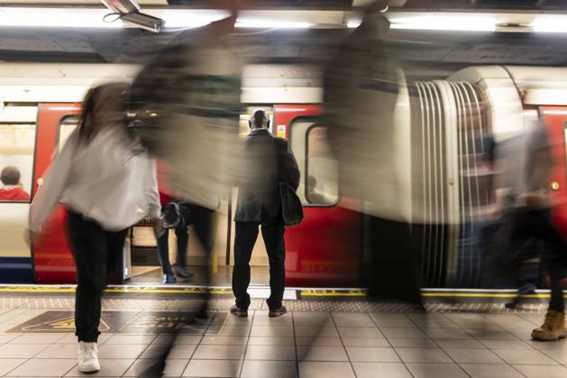 IMAGO Creative, Urban Lifestyle Businessman surrounded by commuters at subway station model released, Symbolfoto, WPEF06415
