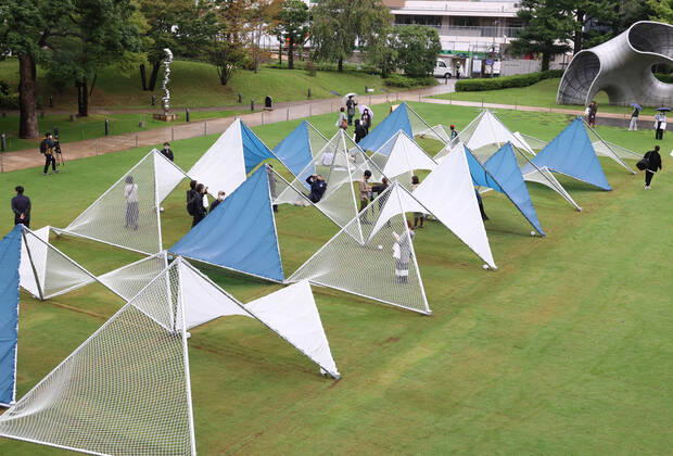 October 14, 2022, Tokyo, Japan - A large installation Sea Hammock formed by tarps and fishnets created by Japanese architect Yuko Nagayama is displayed on the lawn field as a part of the Tokyo Midtown Design Touch 2022 in Tokyo on Friday, October 14, 2022. An annual design event with the theme of Design for Sustainable Future started at the Tokyo Midtown through November 3.  , aflo_201255363.jpg,