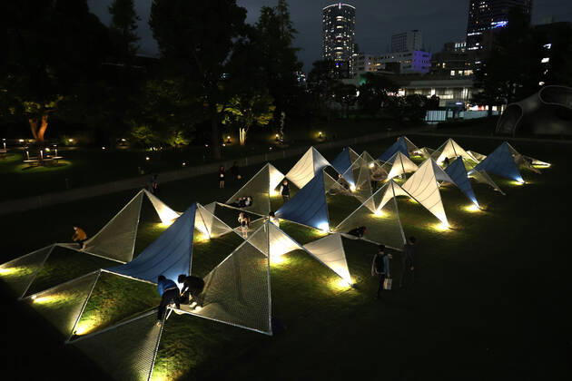 October 14, 2022, Tokyo, Japan - A large installation Sea Hammock formed by tarps and fishnets created by Japanese architect Yuko Nagayama is displayed on the lawn field as a part of the Tokyo Midtown Design Touch 2022 in Tokyo on Friday, October 14, 2022. An annual design event with the theme of Design for Sustainable Future started at the Tokyo Midtown through November 3.  , aflo_201255367.jpg,