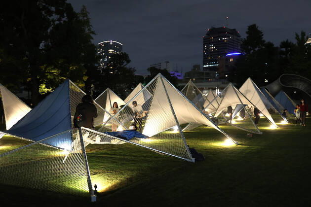 October 14, 2022, Tokyo, Japan - A large installation Sea Hammock formed by tarps and fishnets created by Japanese architect Yuko Nagayama is displayed on the lawn field as a part of the Tokyo Midtown Design Touch 2022 in Tokyo on Friday, October 14, 2022. An annual design event with the theme of Design for Sustainable Future started at the Tokyo Midtown through November 3. , aflo_201255368.jpg,