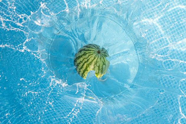 Watermelon falling into swimming pool, JAQF01044
