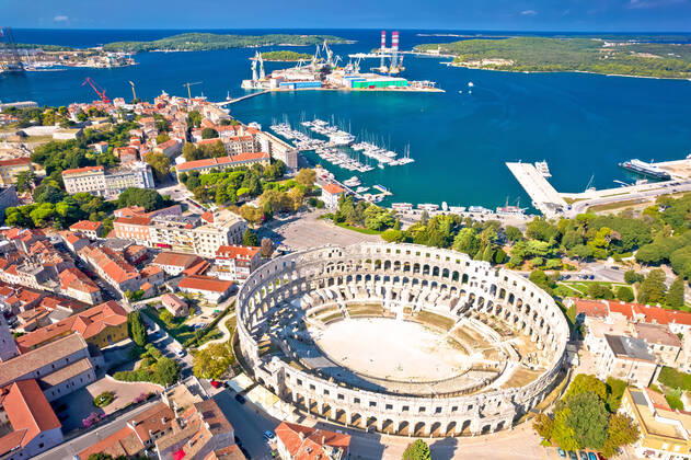 Arena Pula. Ancient ruins of Roman amphitheatre and Pula waterfront aerial view Arena Pula. Ancient ruins of Roman amphitheatre and Pula waterfront aerial view, Istria region of Croatia Copyright: xZoonar.com DaliborxBrlekx 18145033