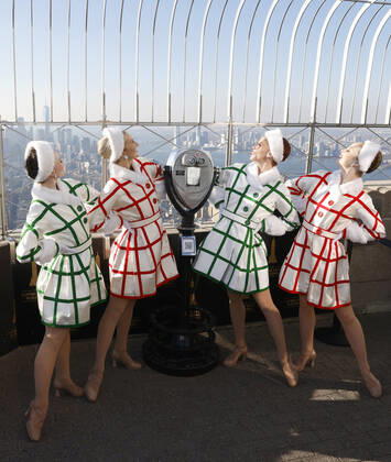 Radio City Rockettes dancers stand on the observation deck of the Empire State Building with a view of the Manhattan skyline in celebration of the opening of the 2022 Christmas Spectacular starring the Radio City Rockettes on Friday, November 18, 2022 in New York City.  NYP20221118105 JOHNxANGELILLO