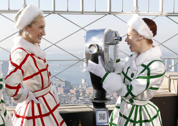 Radio City Rockettes dancers stand on the observation deck of the Empire State Building with a view of the Manhattan skyline in celebration of the opening of the 2022 Christmas Spectacular starring the Radio City Rockettes on Friday, November 18, 2022 in New York City.  NYP20221118106 JOHNxANGELILLO